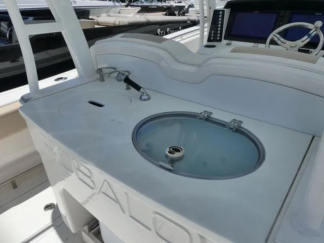 Slide: The Image of 2018 Robalo R302 Center Console with helm and sink. - 8