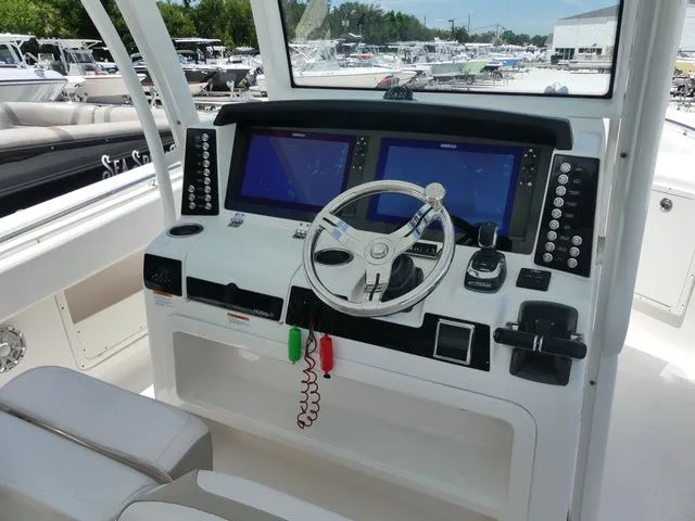 Slide: The Image of 2018 Robalo R302 Center Console helm with dual screens. - 9