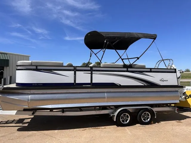 Slide: The Image of 2022 Qwest Pontoons 822 LT on trailer, blue sky. - 2