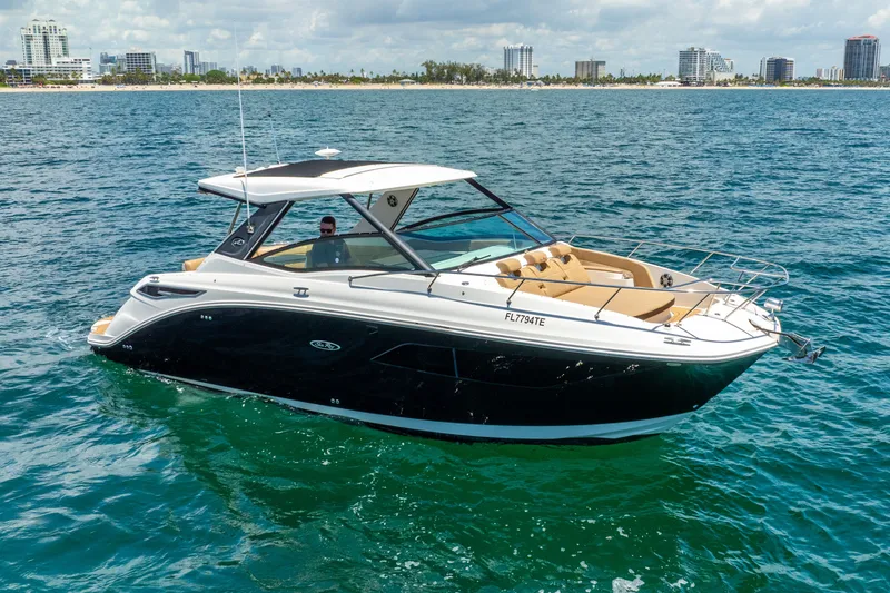 The Image of 2020 Sea Ray Sundancer 320 cruising on the water near the coast. - 0