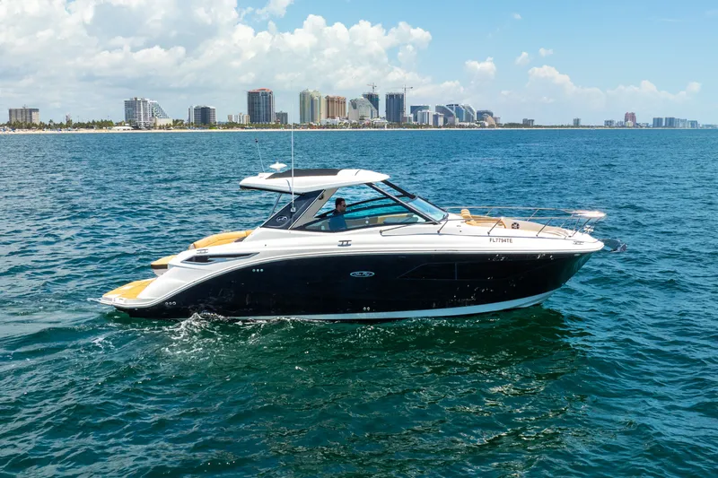 Slide: The Image of 2020 Sea Ray Sundancer 320 on water with city skyline. - 6