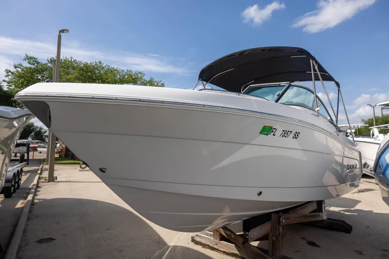 The Image of 2020 Robalo R227 Dual Console boat on display, featuring sleek design and canopy. - 0