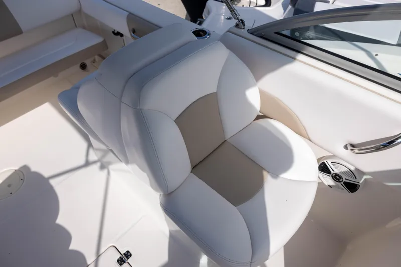 Slide: The Image of 2020 Robalo R227 Dual Console boat seat with white and beige upholstery. - 11