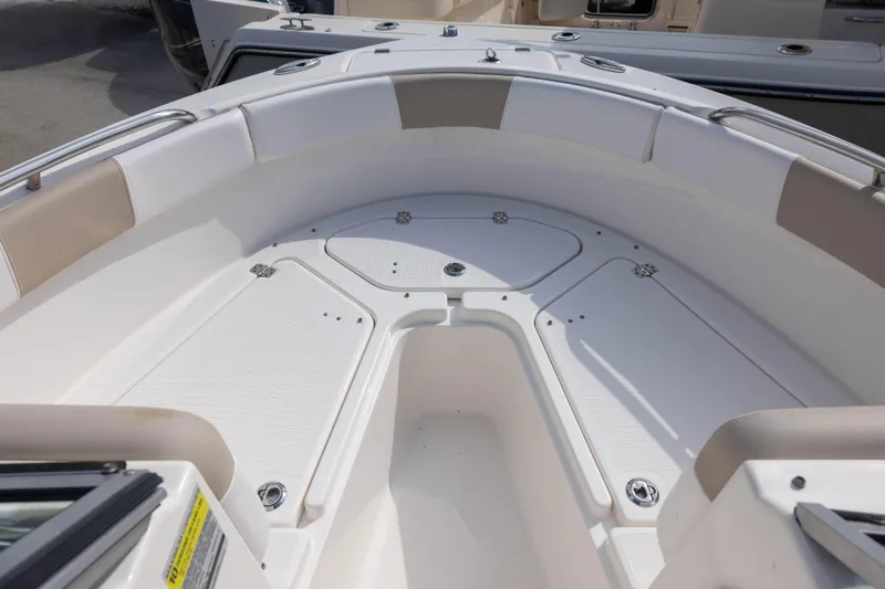 Slide: The Image of 2020 Robalo R227 Dual Console boat interior with cushioned seating and storage compartments. - 12