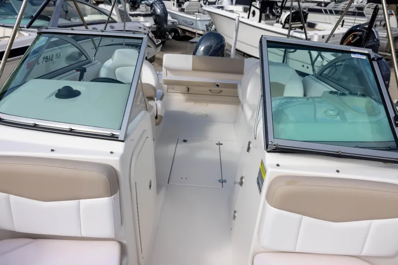 Slide: The Image of 2020 Robalo R227 Dual Console boat interior with seating and windshield. - 16