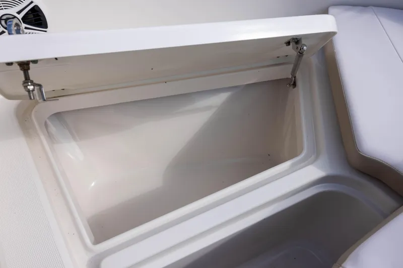 Slide: The Image of Open storage compartment on a 2020 Robalo R227 Dual Console boat. - 18