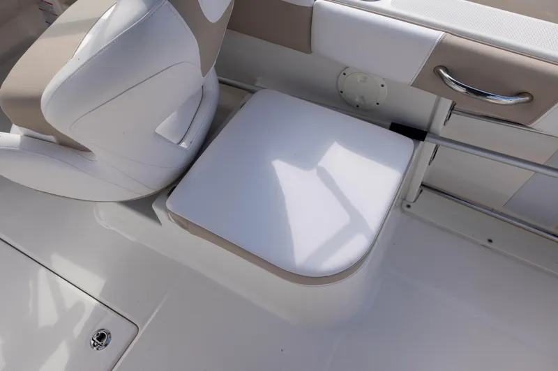 Slide: The Image of 2020 Robalo R227 Dual Console boat seating area with white and beige upholstery. - 19