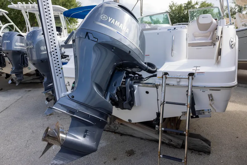 Slide: The Image of 2020 Robalo R227 Dual Console with Yamaha outboard motor, docked on land. - 4