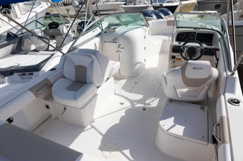 Slide: The Image of 2020 Robalo R227 Dual Console boat interior with seating and steering wheel. - 5