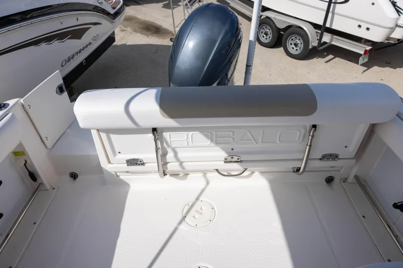 Slide: The Image of 2020 Robalo R227 Dual Console boat interior with seating and engine view. - 6