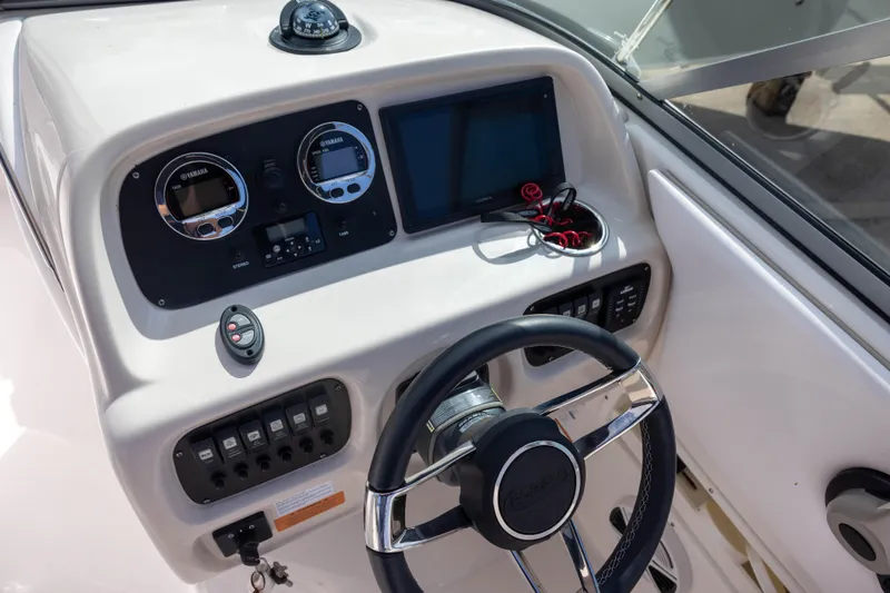 Slide: The Image of 2020 Robalo R227 Dual Console dashboard with steering wheel and navigation instruments. - 9