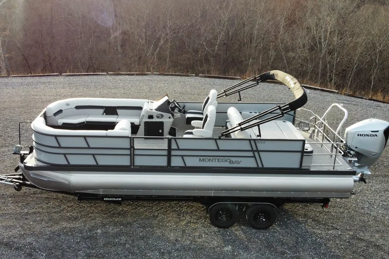 The Image of 2026 Montego Bay ST8524 SB DLX pontoon boat on trailer, side view. - 1