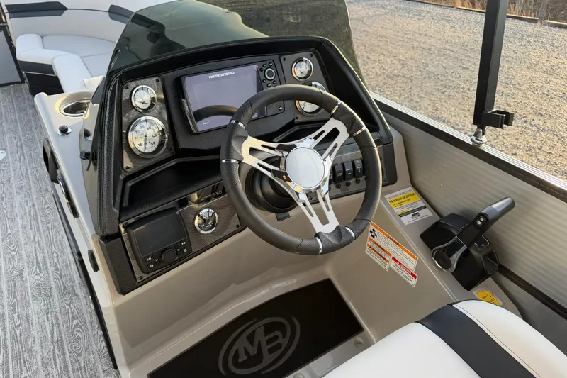 Slide: The Image of Cockpit of 2026 Montego Bay ST8524 SB DLX boat with steering wheel and control panel. - 17