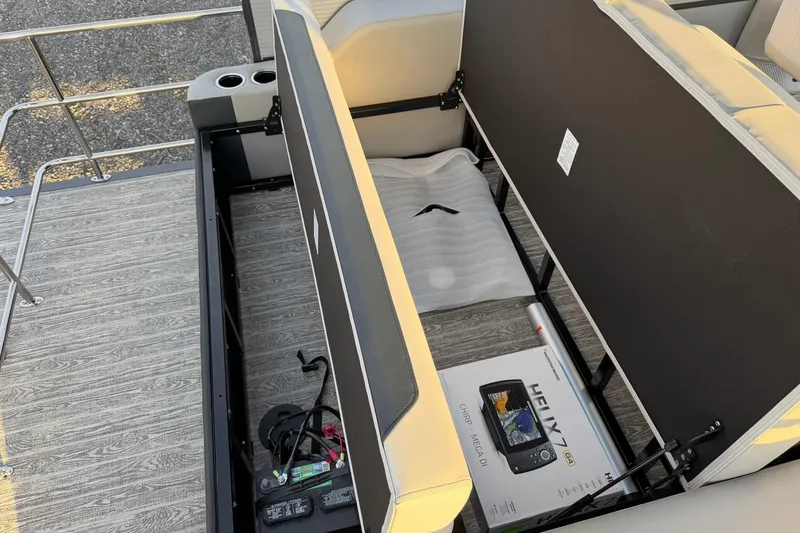 Slide: The Image of Open storage compartment on 2026 Montego Bay ST8524 SB DLX boat, revealing equipment and accessories. - 29