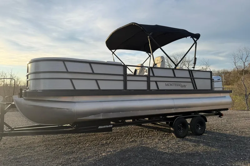 Slide: The Image of 2026 Montego Bay ST8524 SB DLX pontoon boat on trailer at sunset. - 8