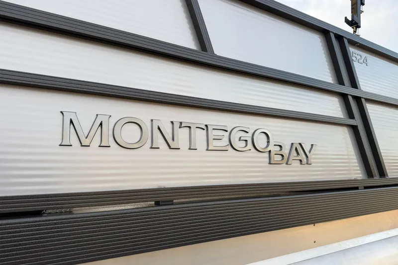 Slide: The Image of 2026 Montego Bay ST8524 SB DLX boat exterior with sleek design and branding. - 9