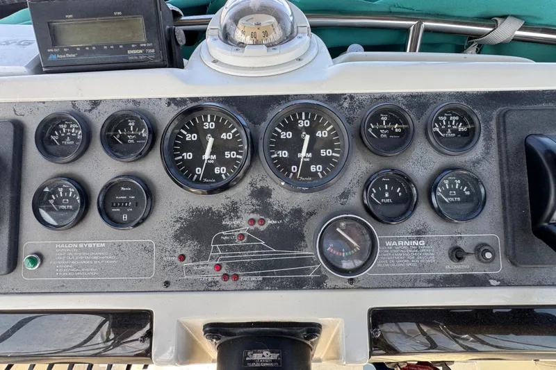 Slide: The Image of 1995 Silverton 31 Convertible boat dashboard with gauges and controls. - 12