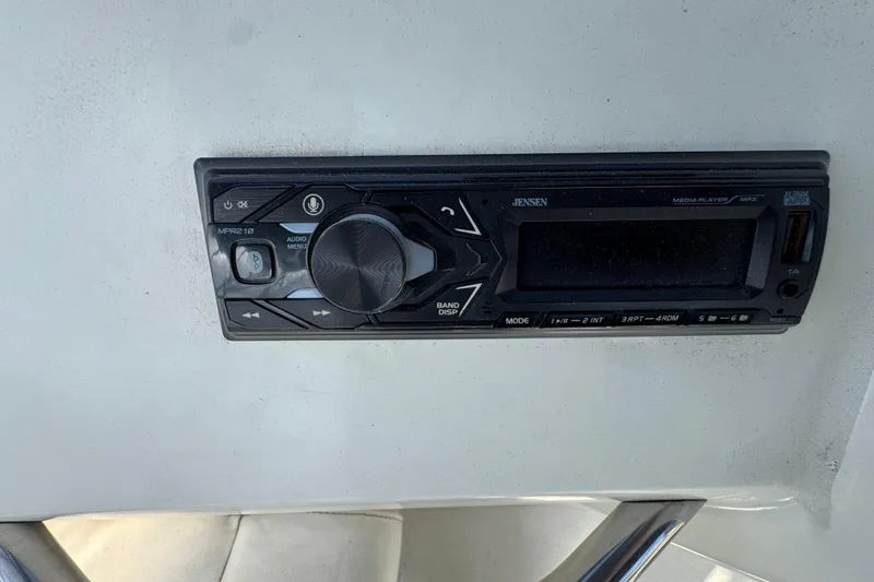 Slide: The Image of Jensen media player on 1995 Silverton 31 Convertible boat dashboard. - 13