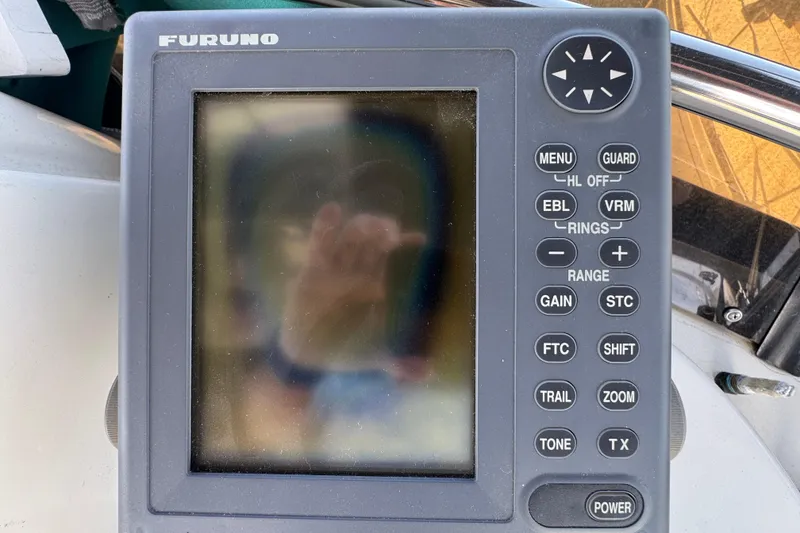 Slide: The Image of Furuno marine navigation device on a 1995 Silverton 31 Convertible boat dashboard. - 15