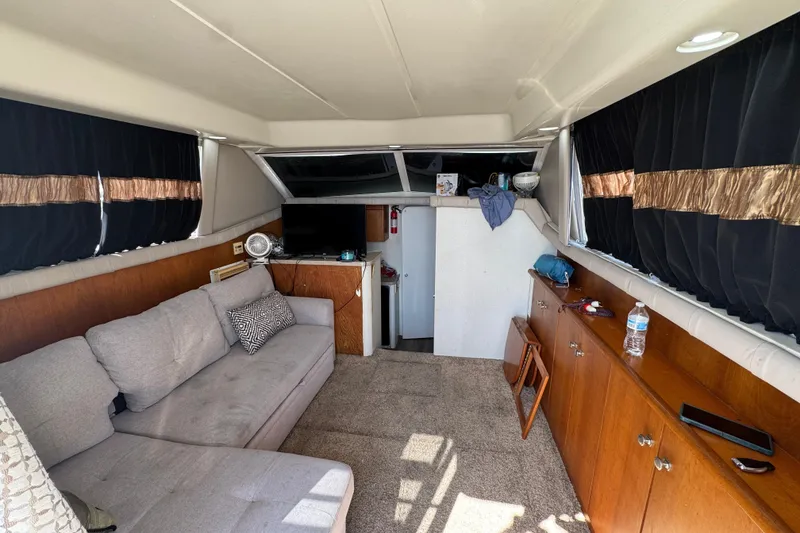 Slide: The Image of Interior of a 1995 Silverton 31 Convertible boat with sofa and TV. - 18