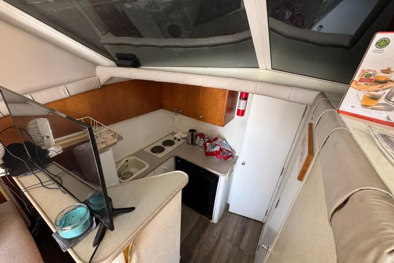 Slide: The Image of Interior view of a 1995 Silverton 31 Convertible boat kitchen area. - 19