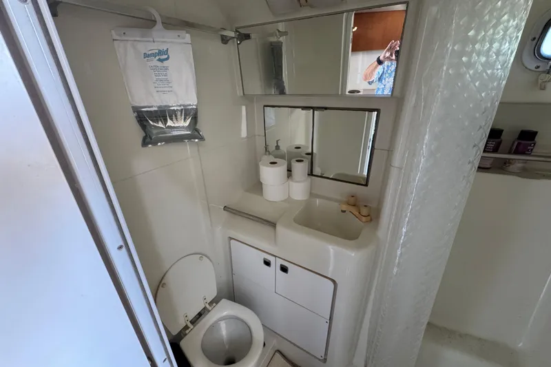 Slide: The Image of Bathroom interior of 1995 Silverton 31 Convertible boat with toilet and sink. - 22