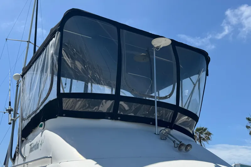 Slide: The Image of 1995 Silverton 31 Convertible boat with enclosed flybridge under clear blue sky. - 4