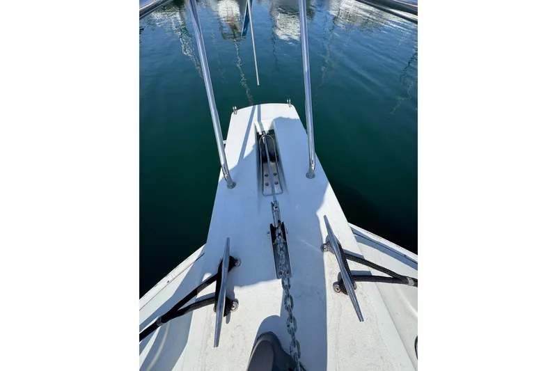 Slide: The Image of Bow view of 1995 Silverton 31 Convertible boat with anchor chain and railing. - 5