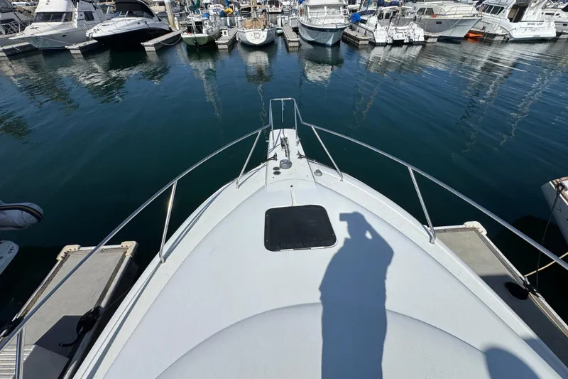 Slide: The Image of Bow view of a 1995 Silverton 31 Convertible docked at a marina. - 8