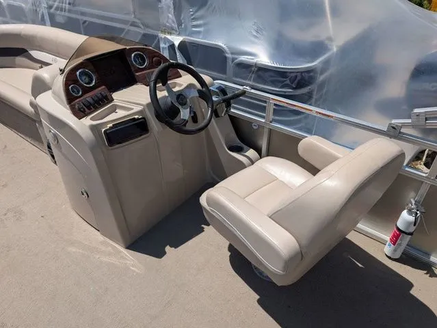 Slide: The Image of Interior of a 2013 Avalon LS Cruise 21' boat with steering console. - 7