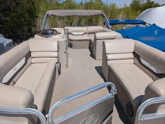 Slide: The Image of 2013 Avalon LS Cruise 21' pontoon boat with beige seating. - 8