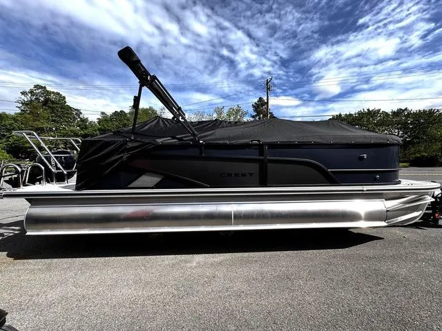 The Image of 2025 Crest Classic 220 SLRC pontoon boat with trailer, covered, in parking lot. - 1