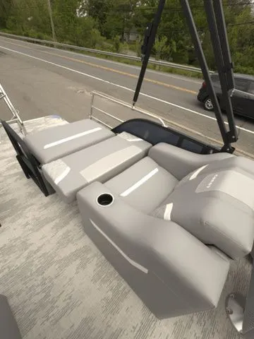 Slide: The Image of 2025 Crest Classic 220 SLRC pontoon boat with gray reclining seats. - 22
