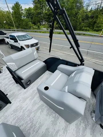 Slide: The Image of 2025 Crest Classic 220 SLRC pontoon boat with gray seating. - 7