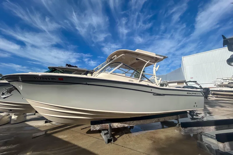 The Image of 2019 Grady-White Freedom 275 boat on display under a vibrant blue sky. - 1