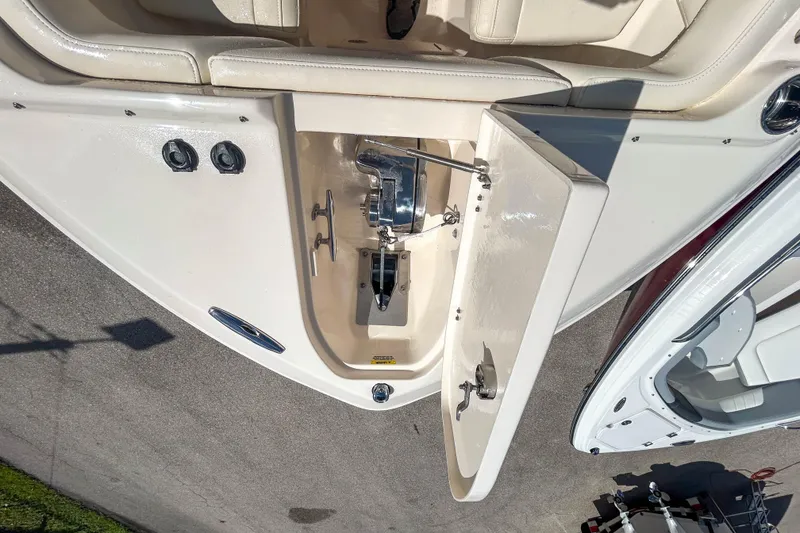 Slide: The Image of 2019 Grady-White Freedom 275 boat anchor compartment with open hatch and seating area. - 11
