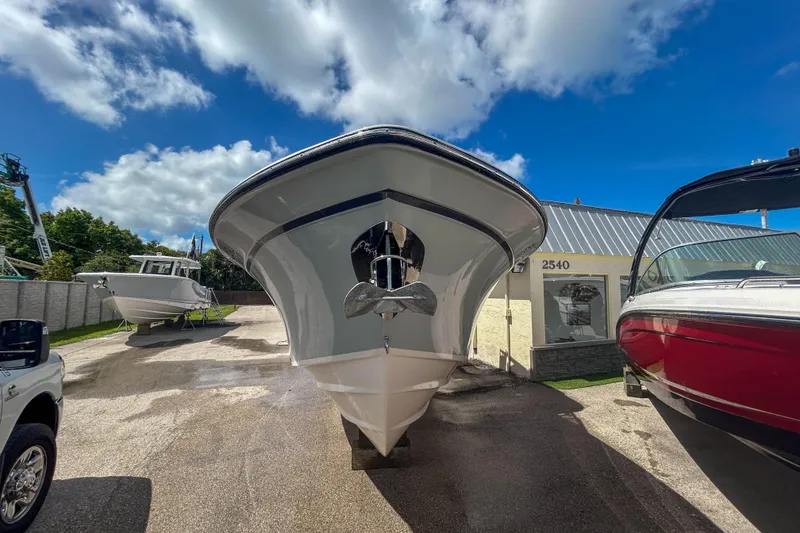 Slide: The Image of 2019 Grady-White Freedom 275 boat displayed outdoors under a clear blue sky. - 13