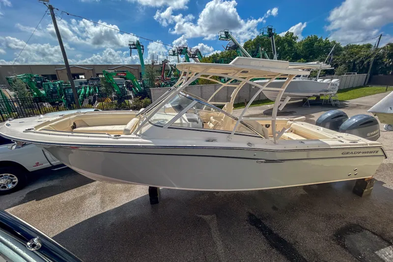Slide: The Image of 2019 Grady-White Freedom 275 boat displayed outdoors under a sunny sky. - 15