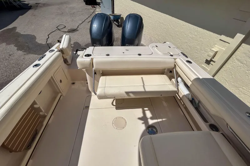 Slide: The Image of 2019 Grady-White Freedom 275 boat interior with dual engines and seating area. - 5