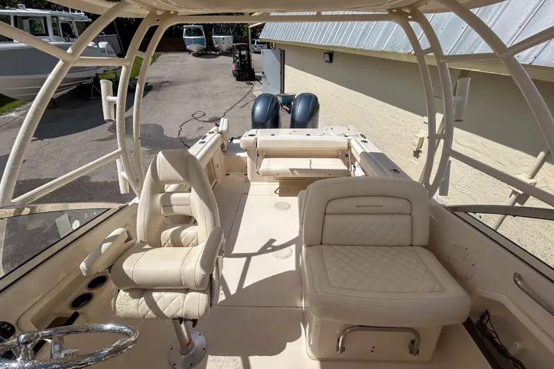 Slide: The Image of 2019 Grady-White Freedom 275 boat interior with luxurious seating and helm. - 8