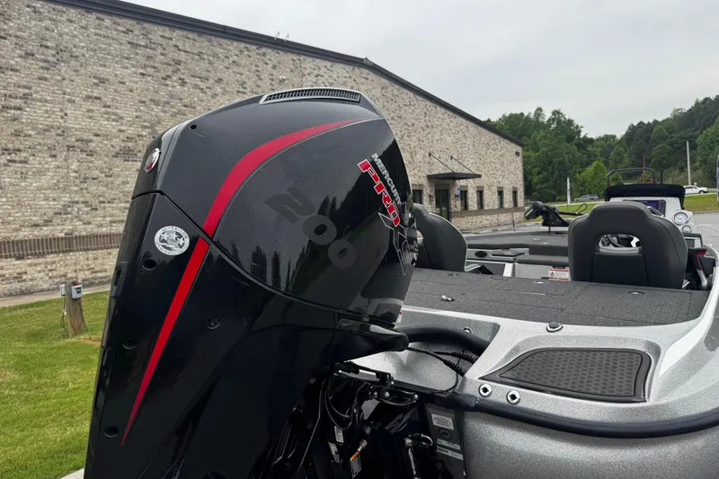 Slide: The Image of 2023 Nitro Z19 boat with Mercury Pro engine, parked outdoors near a brick building. - 13