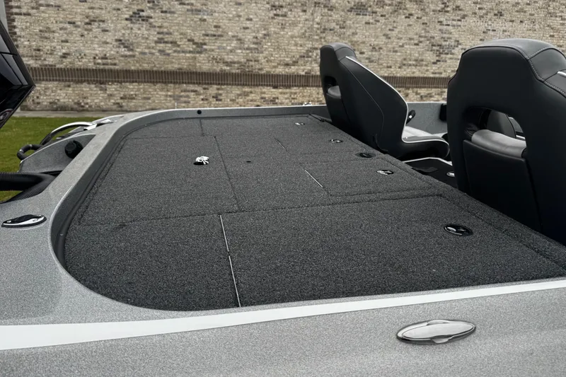 Slide: The Image of 2023 Nitro Z19 boat deck with storage compartments and seating, against a brick wall backdrop. - 14