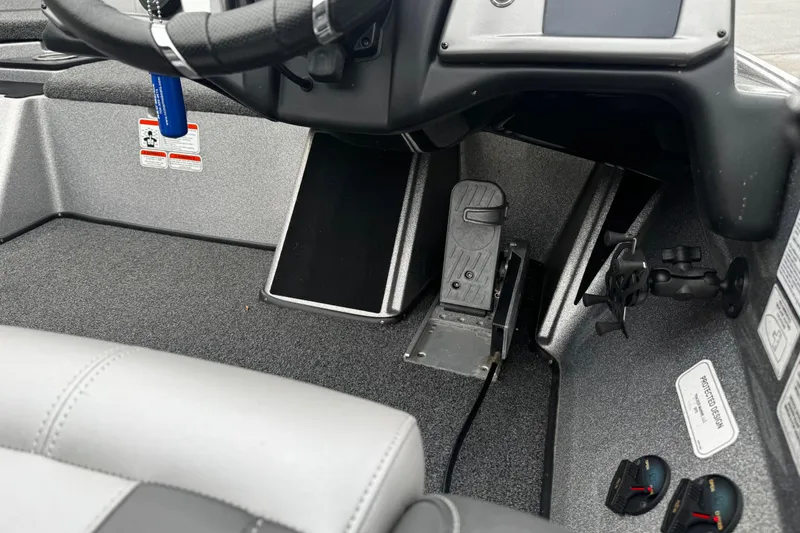 Slide: The Image of Interior of a 2023 Nitro Z19 boat showing steering wheel and foot pedal controls. - 16