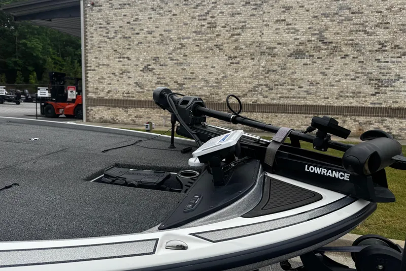 Slide: The Image of 2023 Nitro Z19 boat with Lowrance equipment, parked near a brick wall. - 2