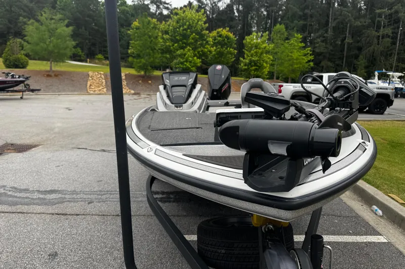 Slide: The Image of 2023 Nitro Z19 boat parked, featuring advanced motor and sleek design in a wooded area. - 3