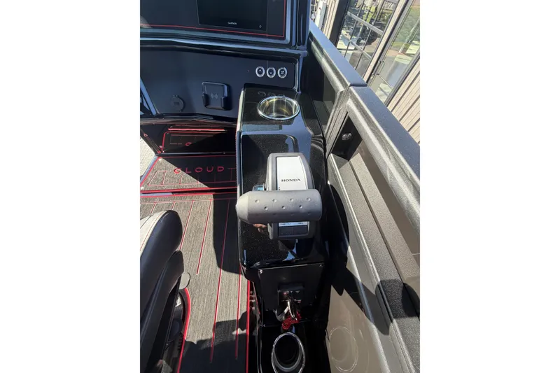 Slide: The Image of Interior view of 2026 Whisper C25 Splash Pad boat with Honda controls and modern dashboard. - 2