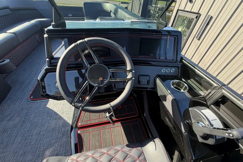 Slide: The Image of Interior of 2026 Whisper C25 Splash Pad boat with modern steering and control panel. - 3