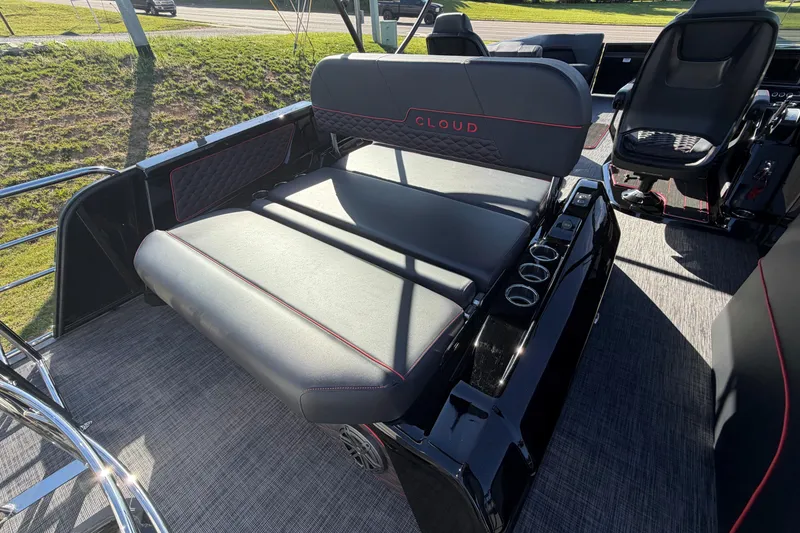 Slide: The Image of Luxurious seating on 2026 Whisper C25 Splash Pad boat, featuring sleek black upholstery and cup holders. - 5