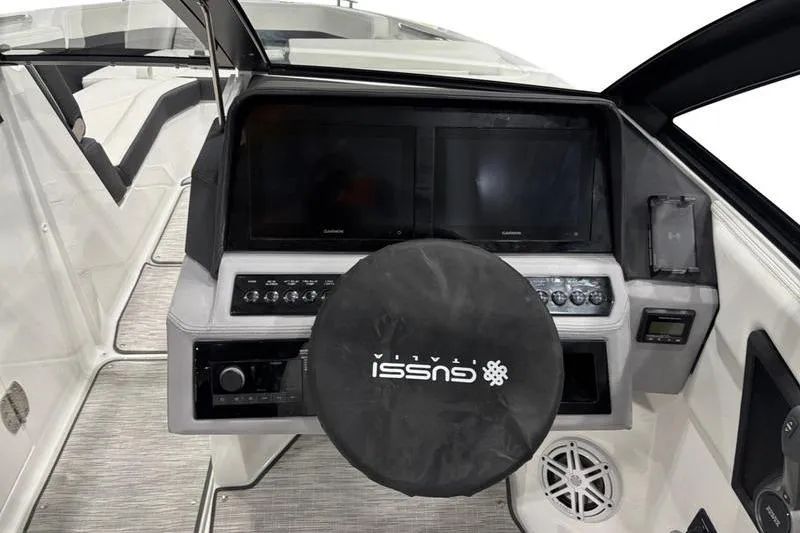 Slide: The Image of 2025 Cobalt R6 boat dashboard with dual screens and Gussi Italia steering wheel cover. - 5