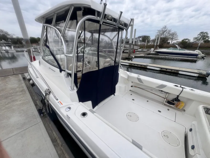 Slide: The Image of 2012 Boston Whaler 235 Conquest docked, side view. - 14